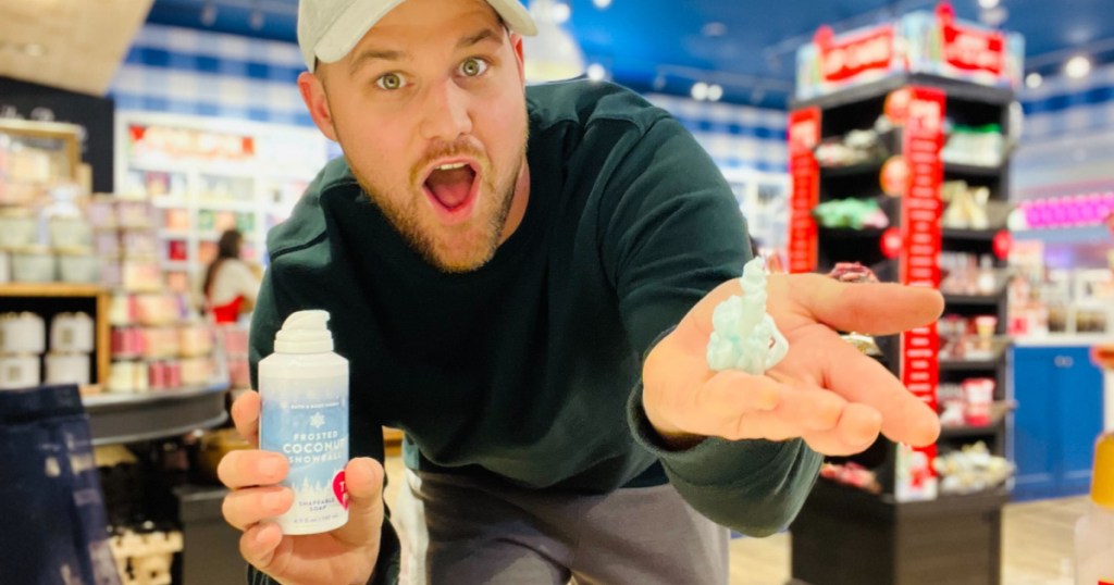man holding Bath & Body Works Shapeable Soap in store and squirting it on his hand