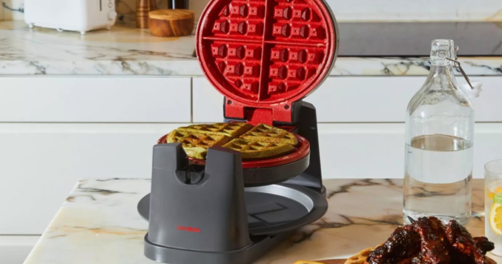 black and red rotating waffle maker on counter