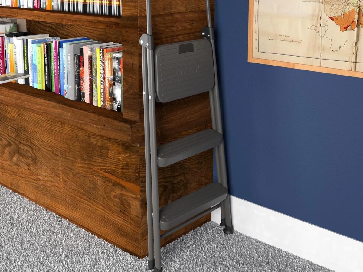 cosco 3 step foldable step stool folded against bookshelf