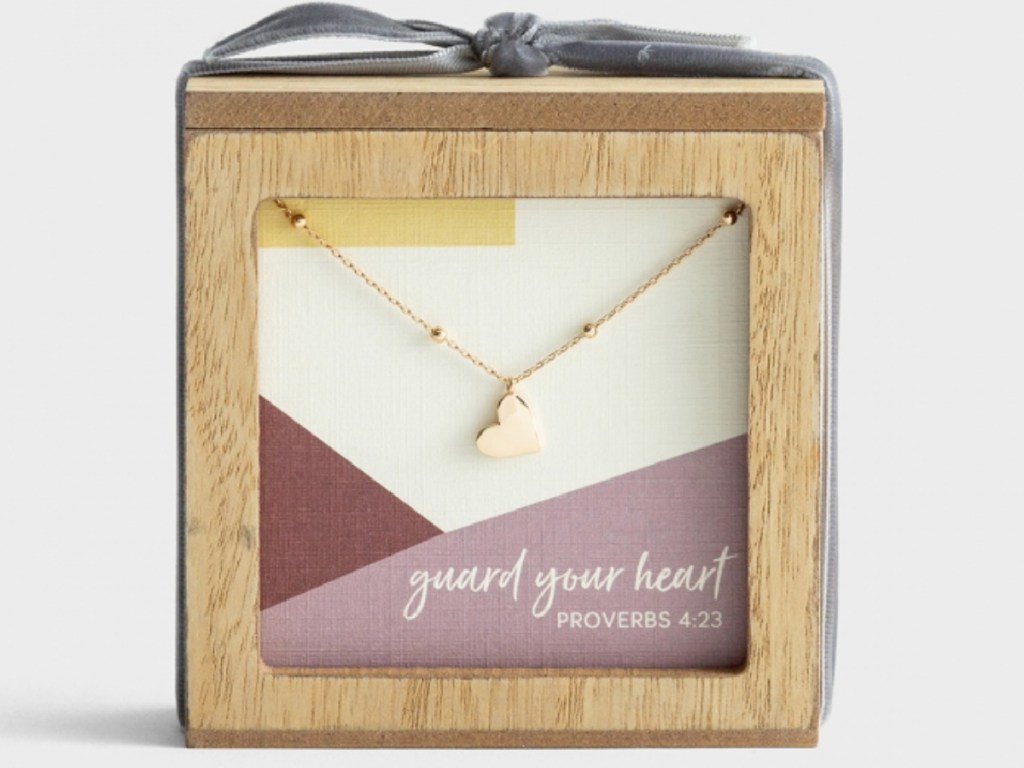 heart necklace hanging inside giftable wooden box