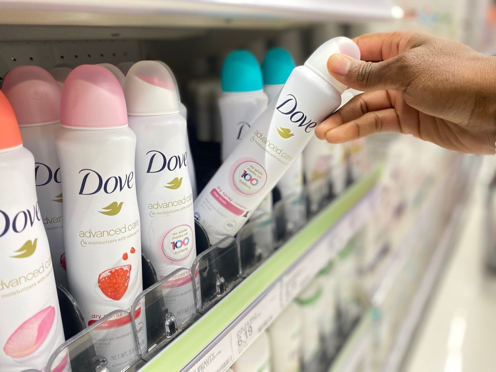 Hand pulling Dove Dry Spray from Target shelf