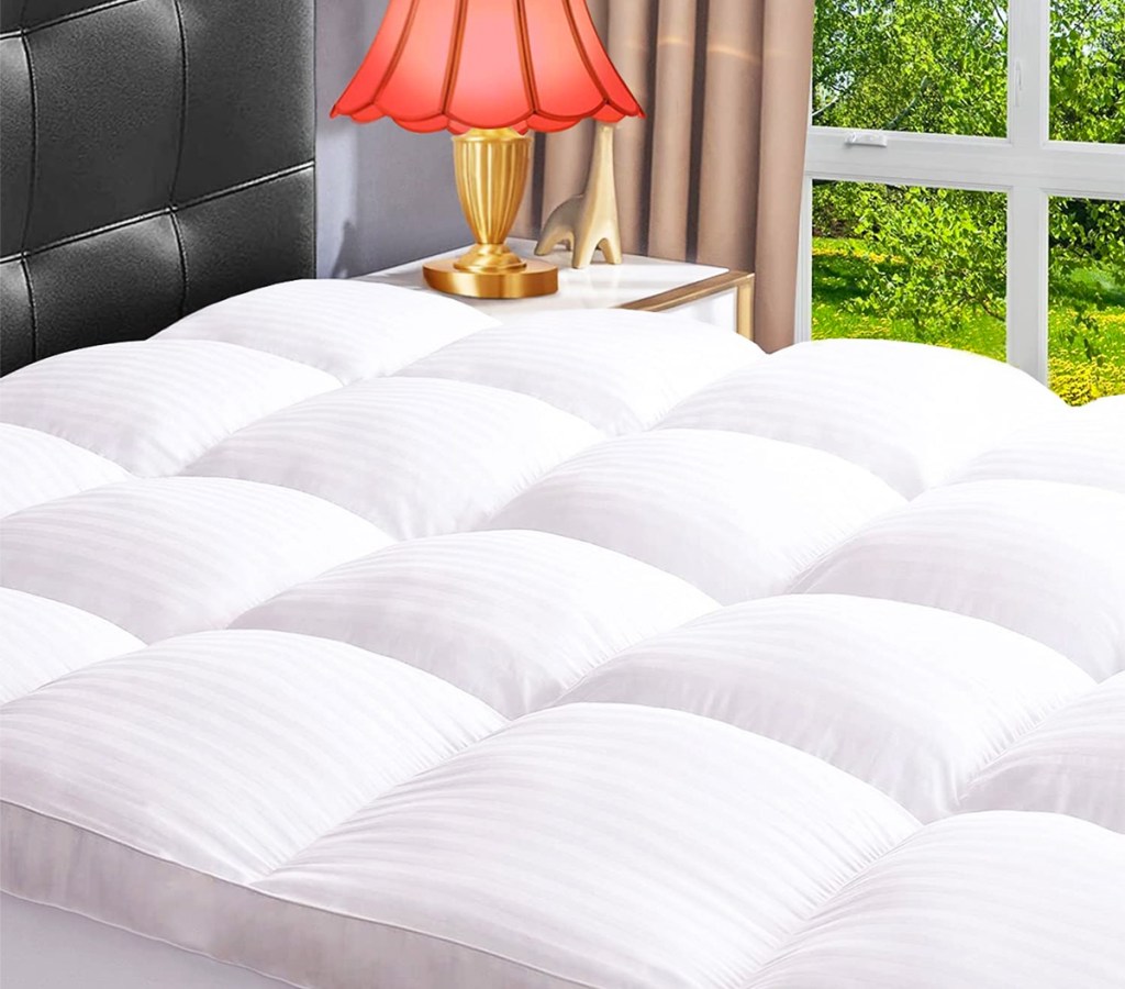 white mattress topper on bed