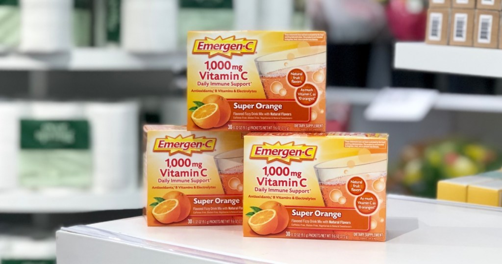 three boxes of 30-count Emergen-C packets in super orange on a store shelf