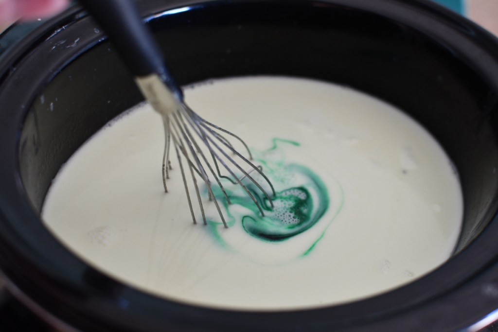 Food coloring swirling in melted cocoa
