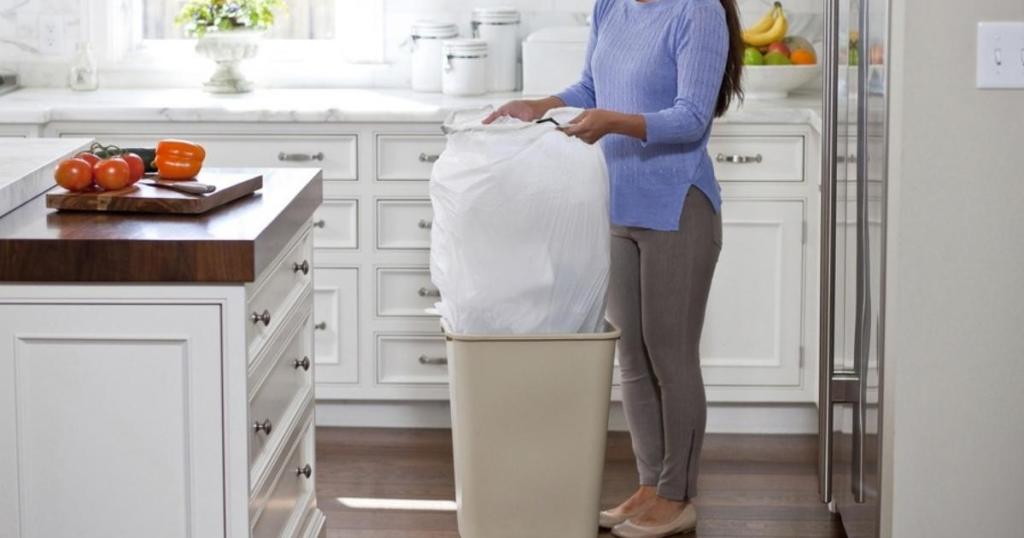 woman with CloroxPro Glad ForceFlex Tall Kitchen Drawstring Trash Bags, 13 Gallon Grey Trash Bag, 100 Count