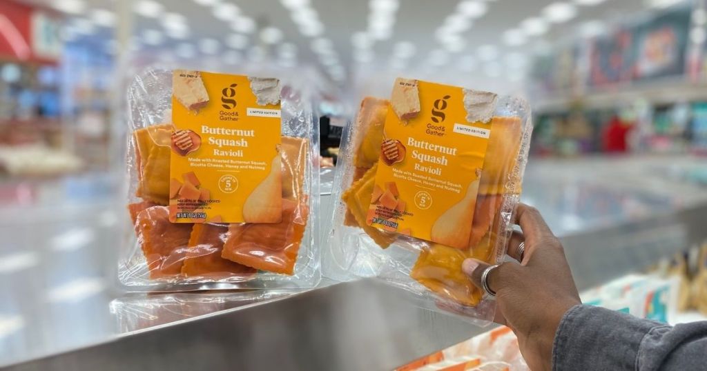 person's hand placing Good & Gather Butternut Squash Ravioli on stainless steel counter