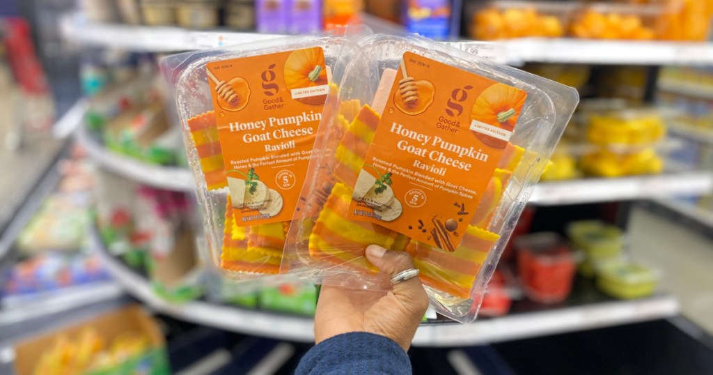 phand holding two packages of pumpkin honey goat cheese ravioli in store