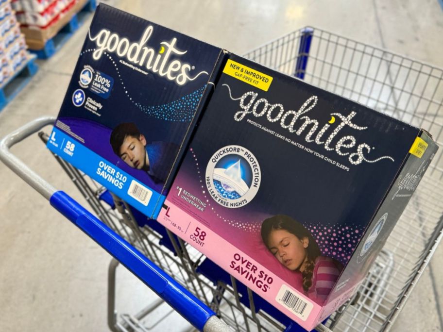 Boxes of Goodnites disposable night time underwear in a Sam's Club shopping cart.