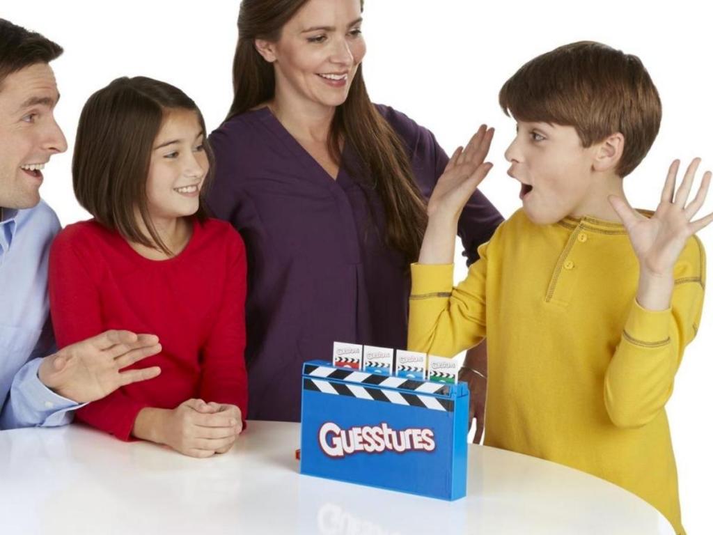 family playing guesstures around table