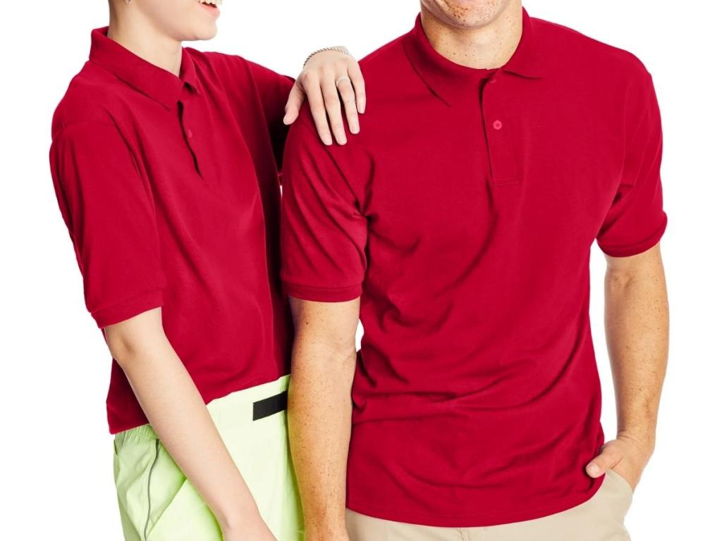 two people wearing red hanes men's cotton polo shirt