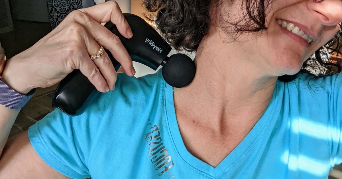 woman using HeyChy Mini Massage Gun on neck