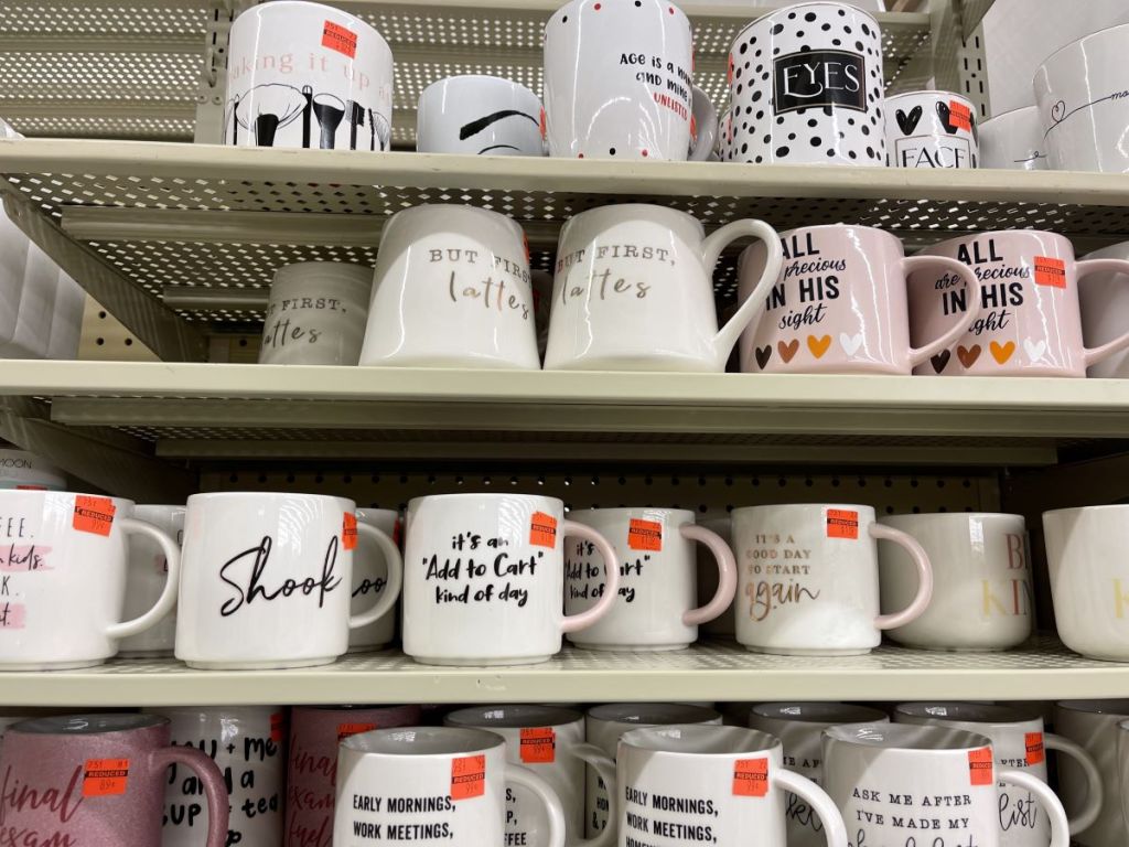 coffee mugs on a shelf at Hobby Lobby