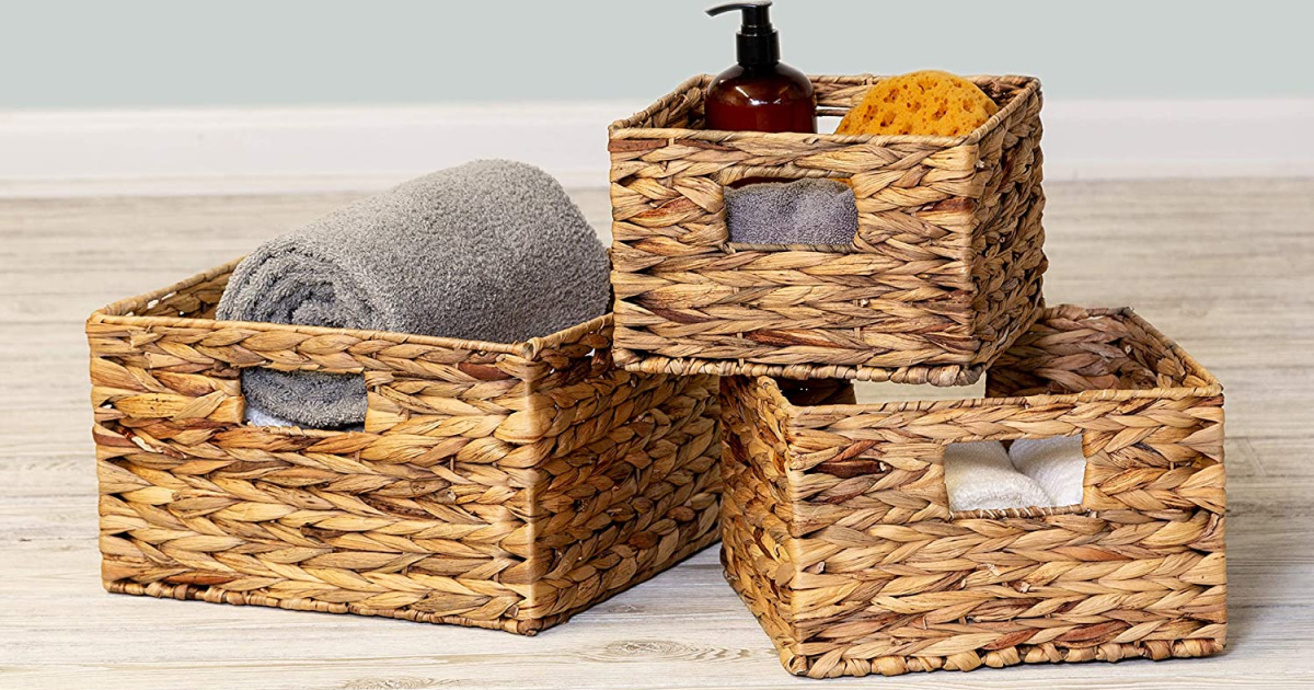three storage baskets filled with bath supplies