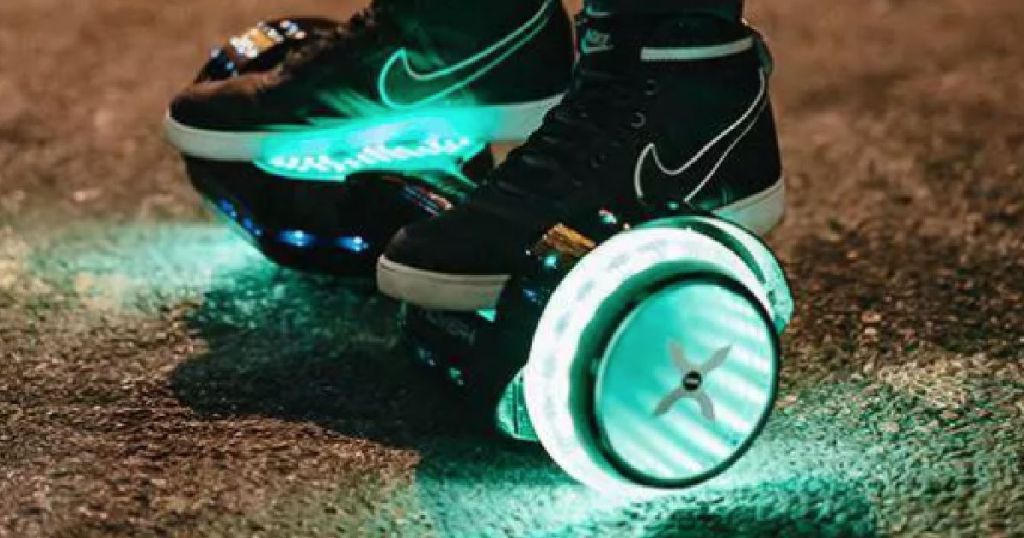 black shoes standing on glowing hoverboard
