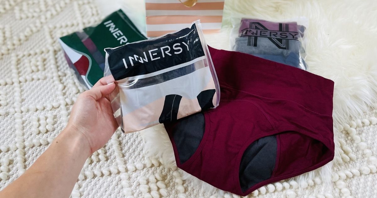woman holding Innersy package with undies on bed