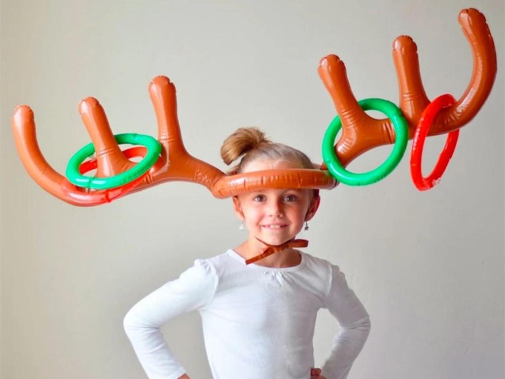 girl with inflatable reindeer ring toss game