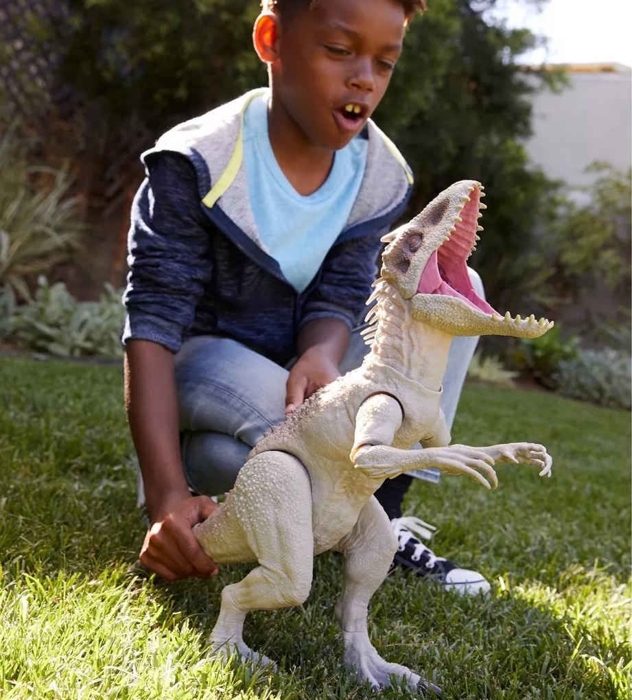 boy playing with Jurassic Park Dino