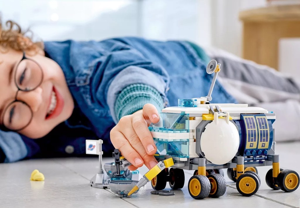 boy playing with a LEGO City Lunar Roving Vehicle Building Kit