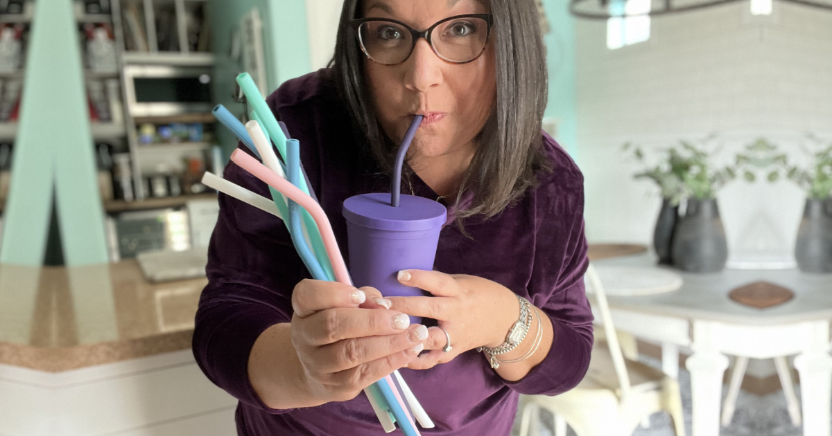 woman holding drinking straws
