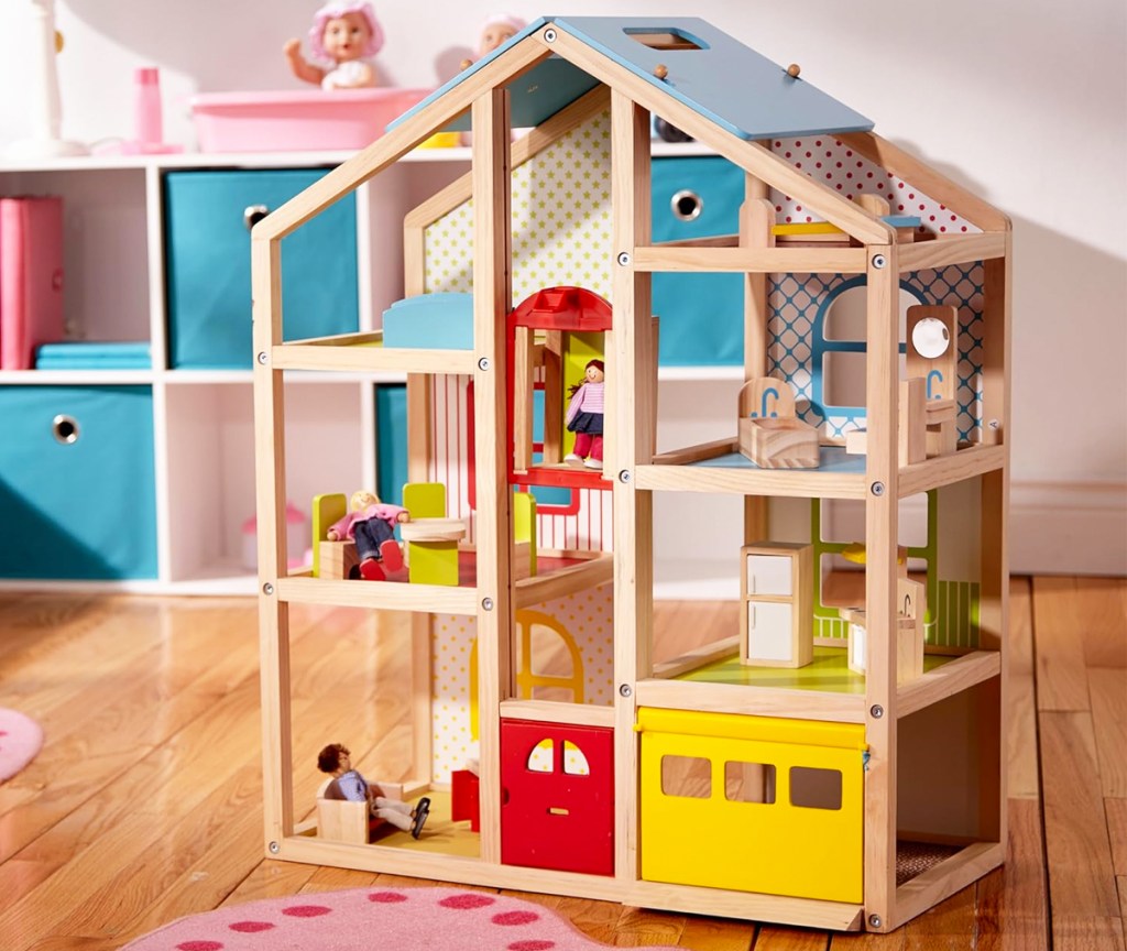 open frame wooden dollhouse on playroom floor