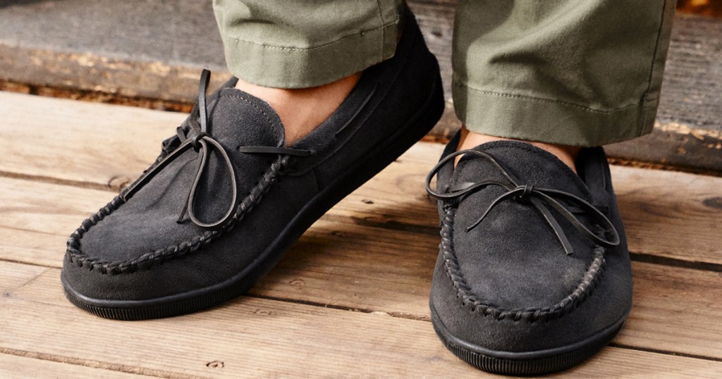 man wearing a pair of black leather moccasins 