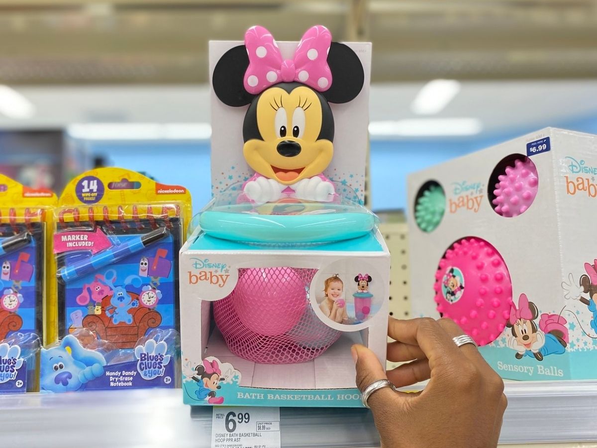 hand holding minnie mouse baby toy in store