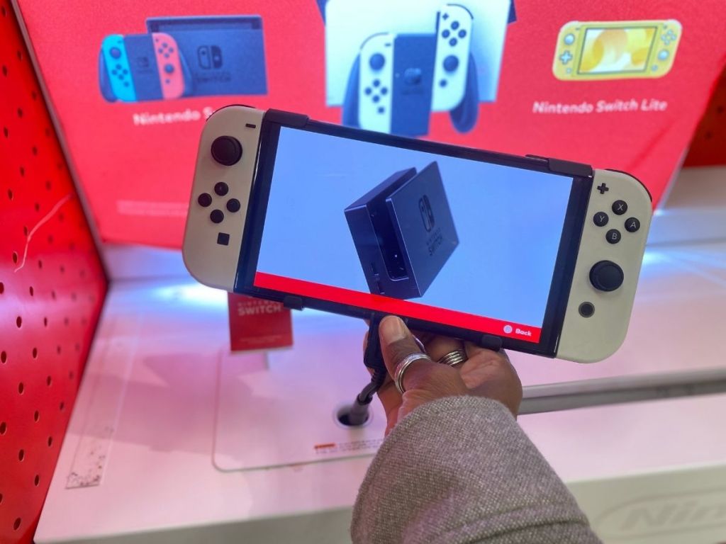 holding a white Nintendo Swtich