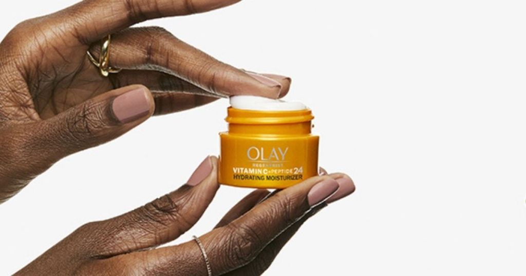 hand holding Olay Vitamin C + Peptide 24 Facial Moisturizer 