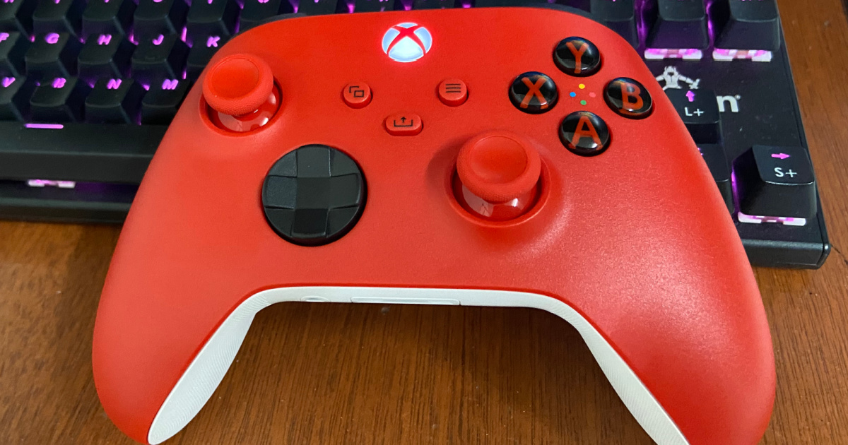 red colored controller for xbox sitting on table
