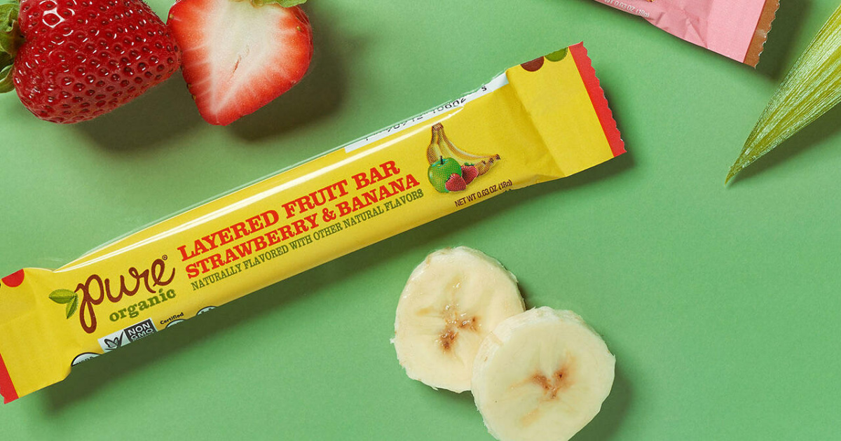 package of pure organic fruit bar surrounded by sliced fruit