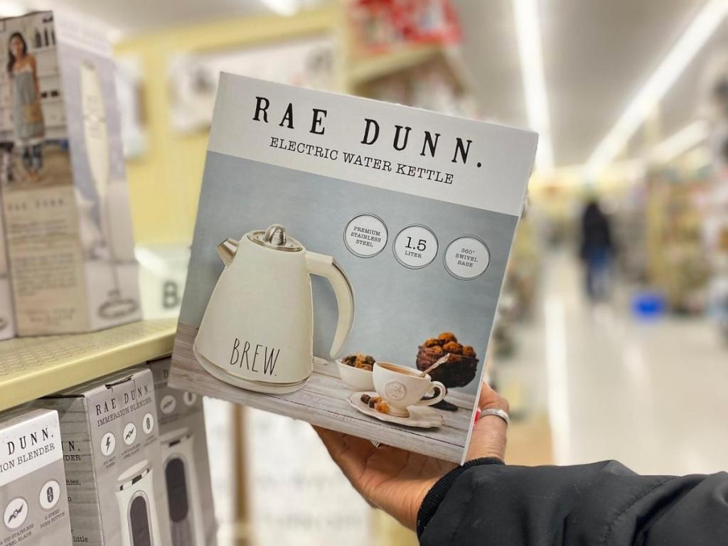 hand holding rae dunn electric tea kettle in store