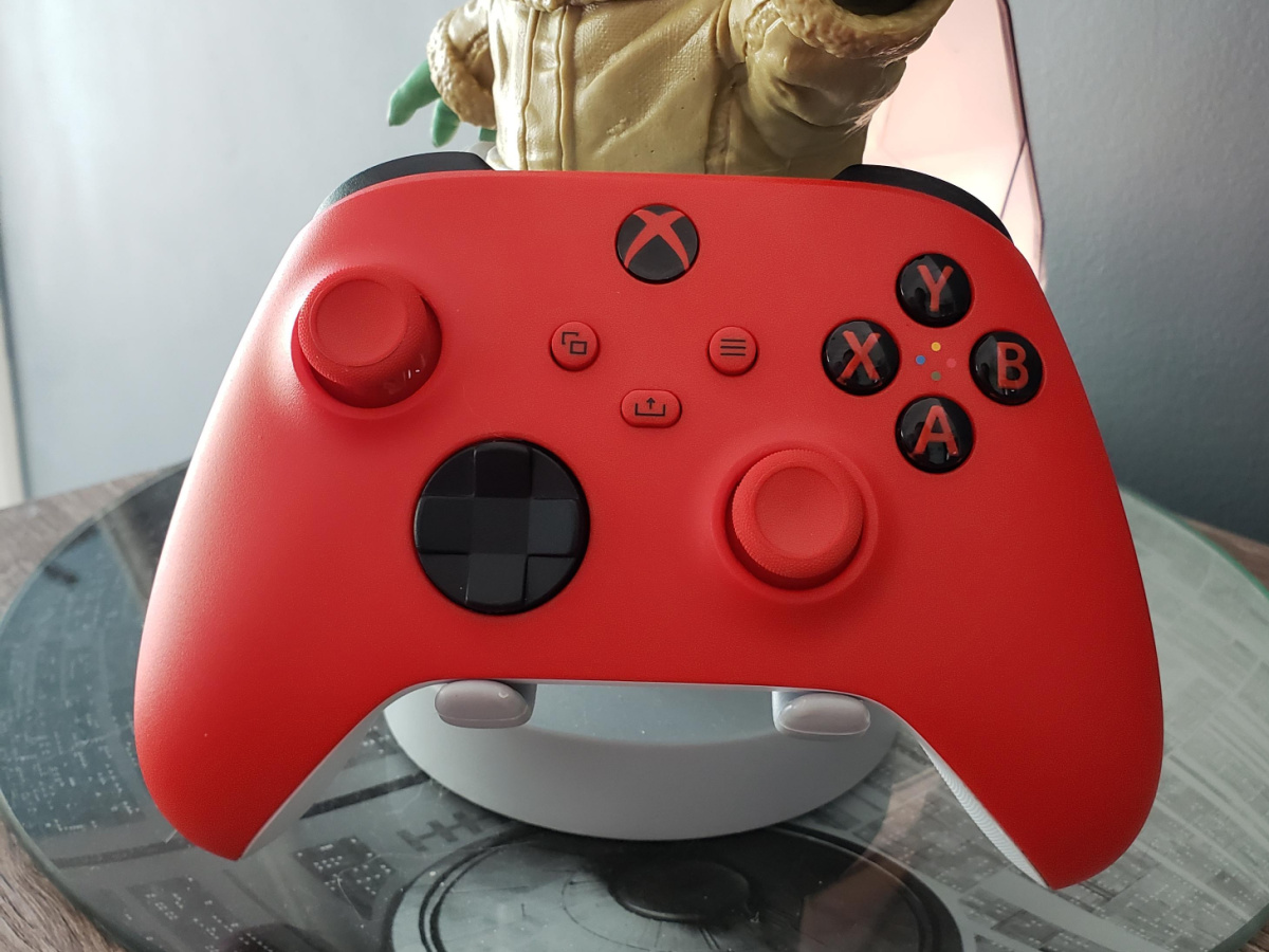red gaming controller sitting on stand at a desk