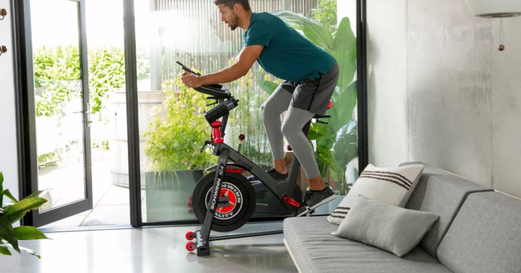 man on exercise bike in living room 