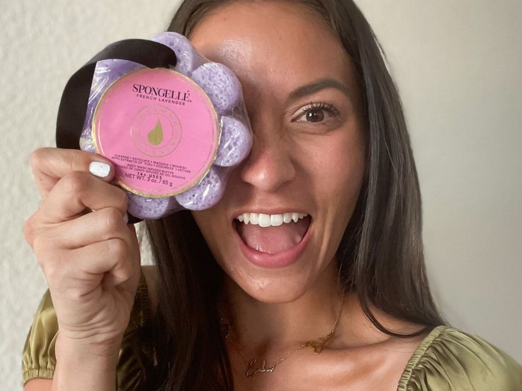 woman holding Spongelle Flower over her eye