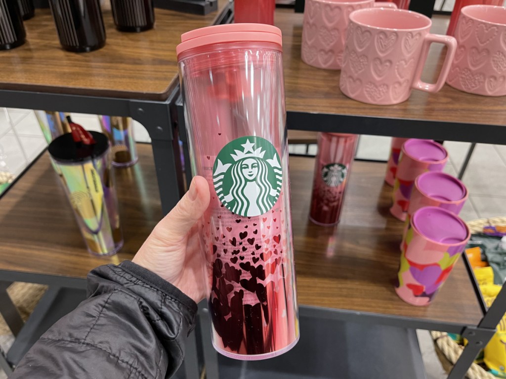 hand holding pink Heart Ombre Tumbler in store