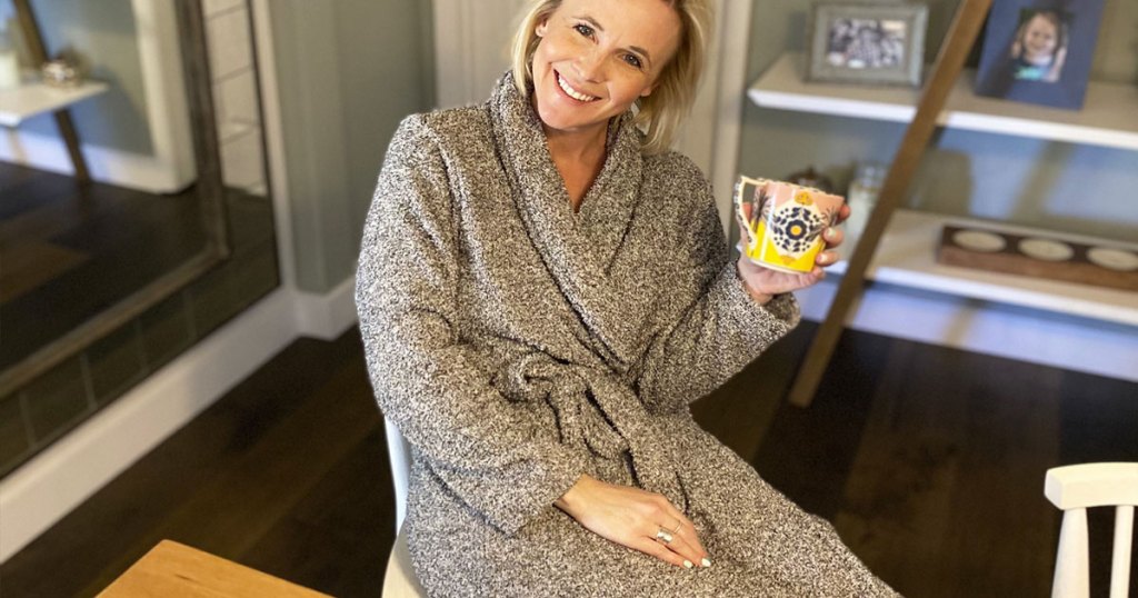 woman in grey robe holding coffee mug