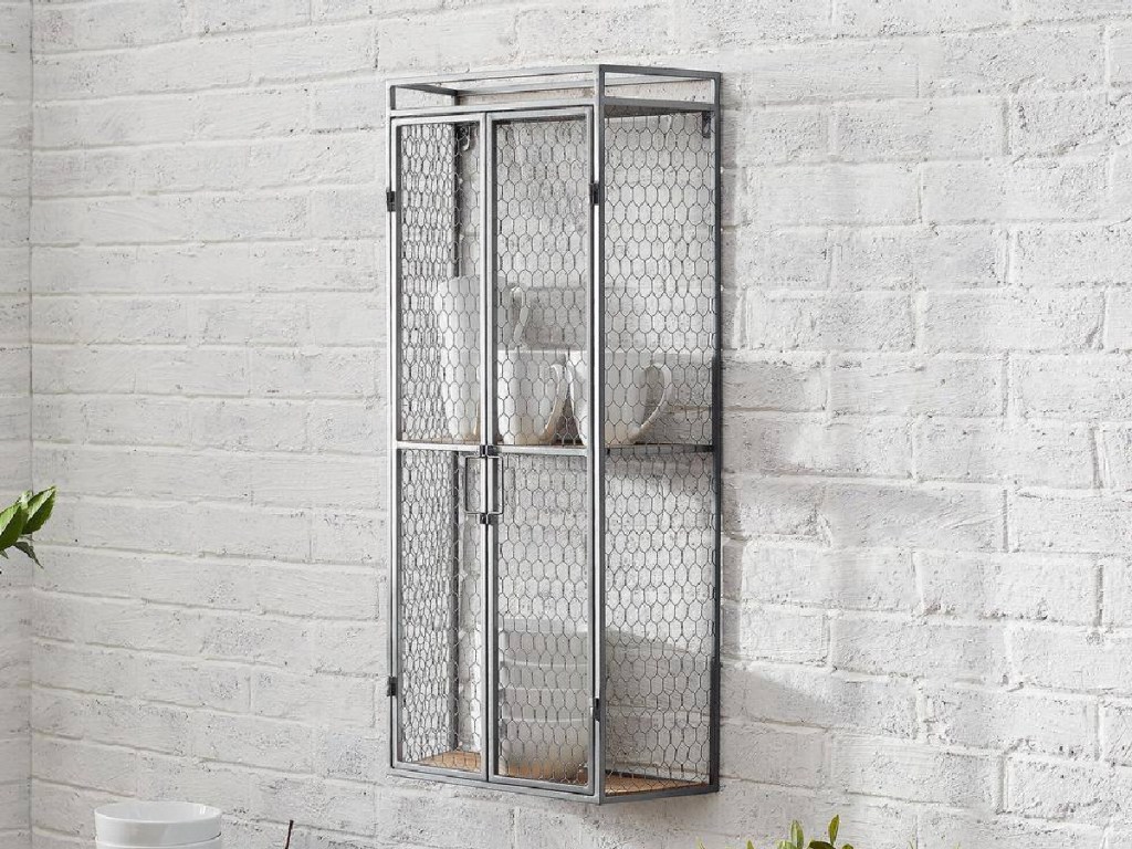 silver shelf with cage doors hanging on wall