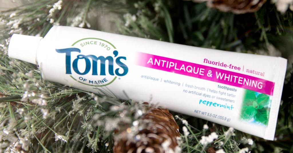 tube of toms of maine toothpaste atop christmas tree