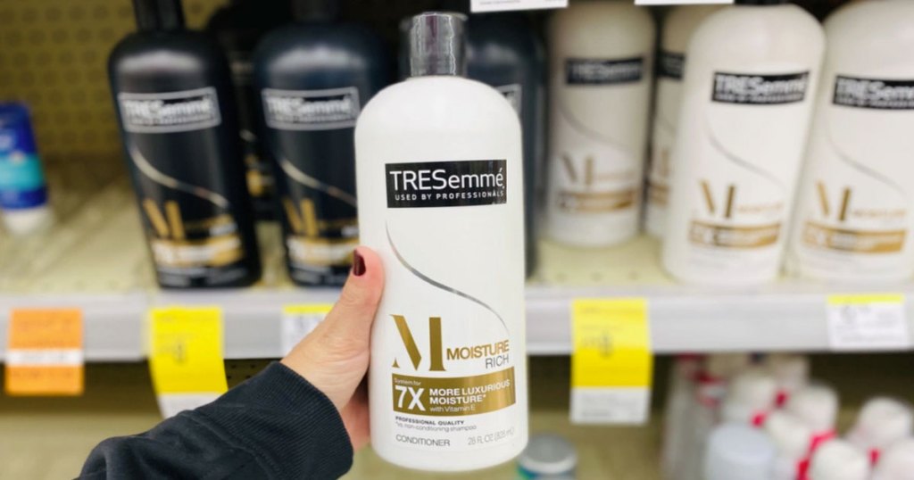 hand holding tresemme conditioner bottle