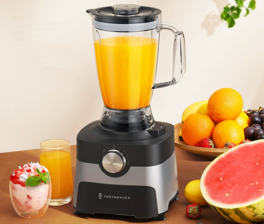 blender cup making orange juice on food processor base
