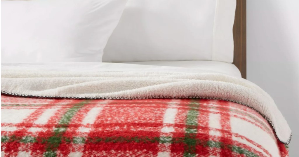 red plaid blanket on bed 
