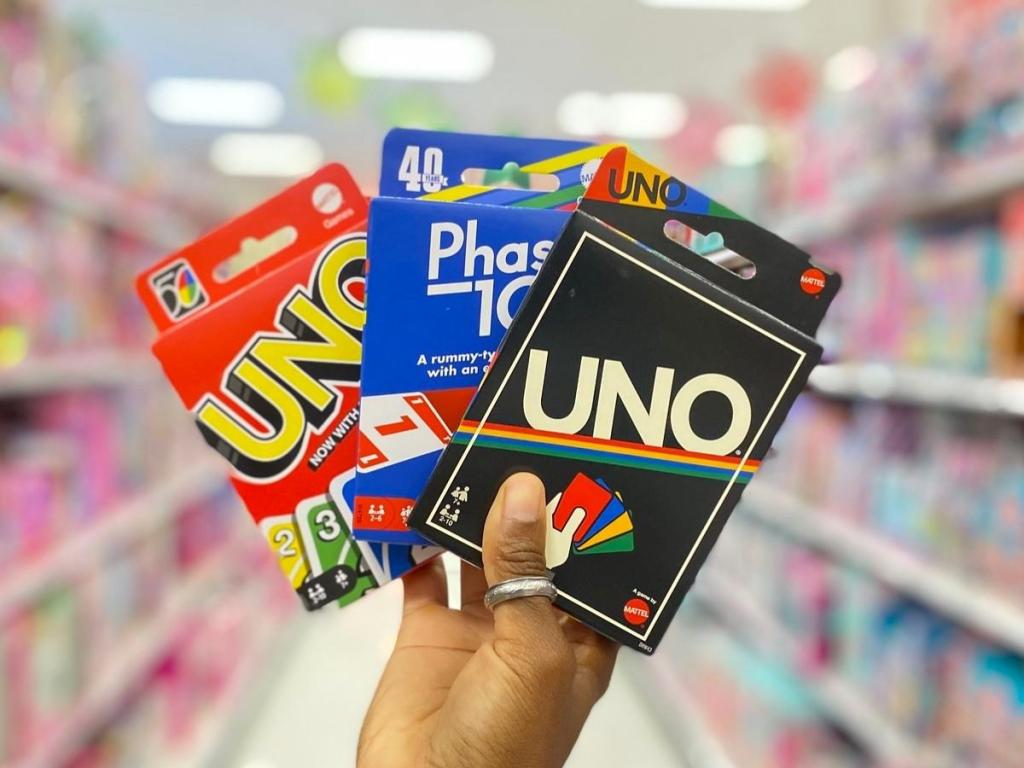 hand holding uno phase 10 and uno retro games