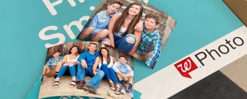 photo prints of family on top of Walgreens photo envelopes