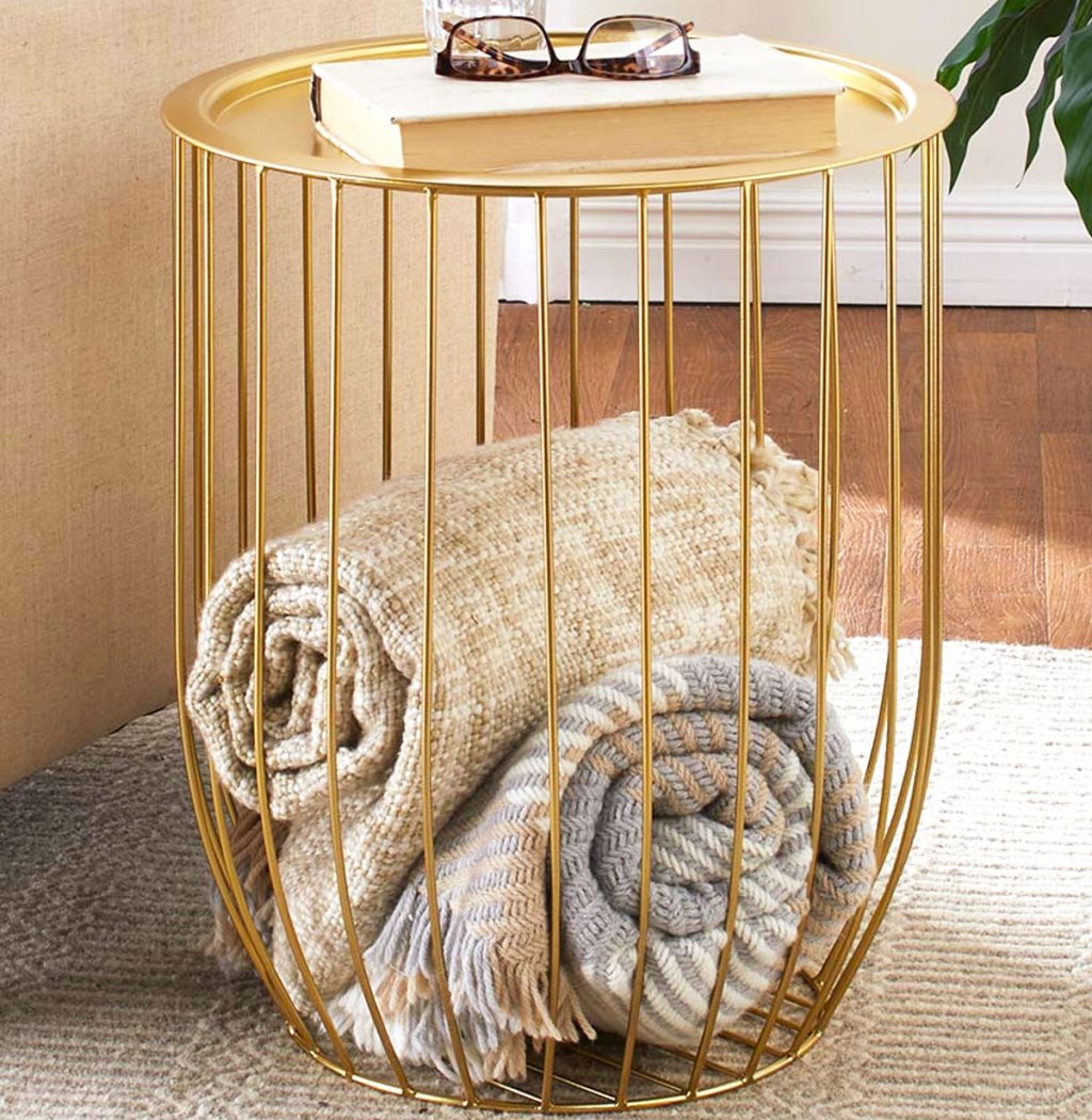 gold wire table with throw blankets inside