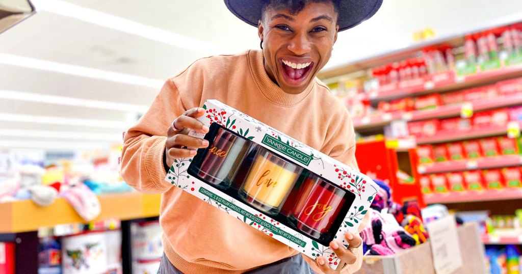 woman holding yankee candle gift set
