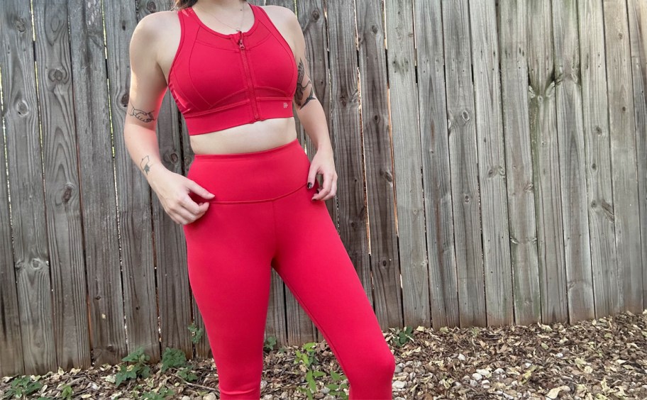 woman wearing matching red sports bra and leggings set