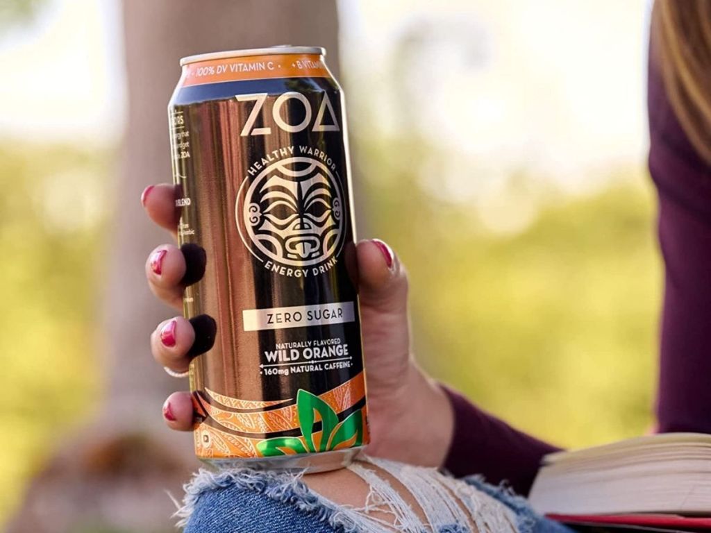 woman holding ZOA Wild Orange drink