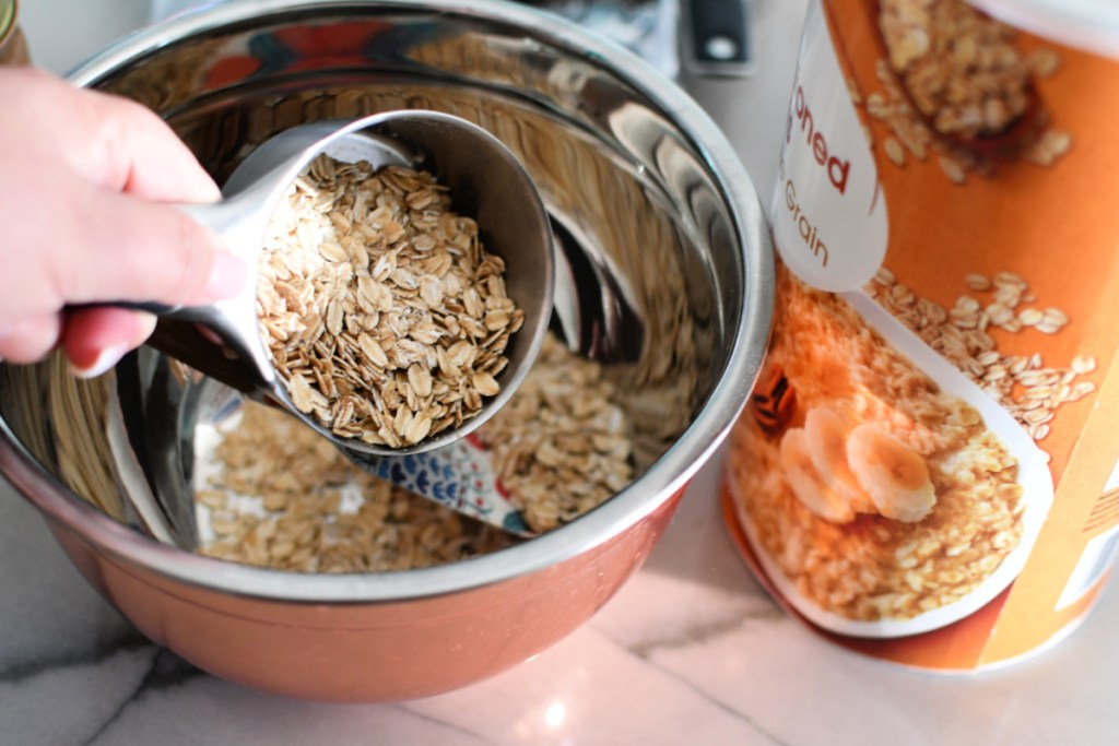 adding oatmeal to mixing bowl