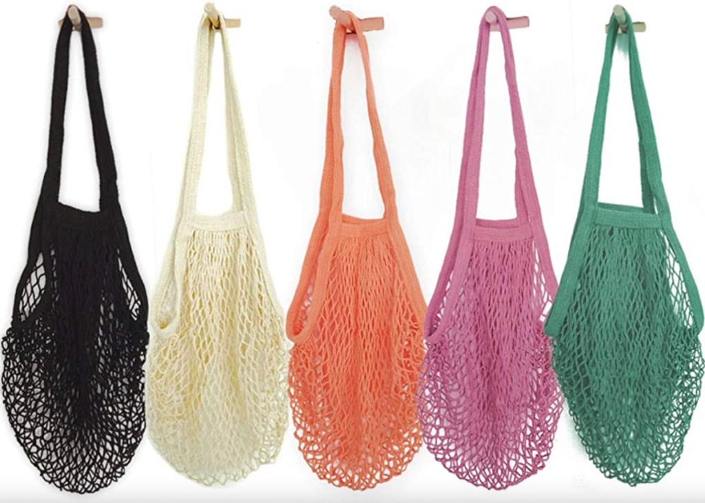row of colorful mesh produce bags on white background 