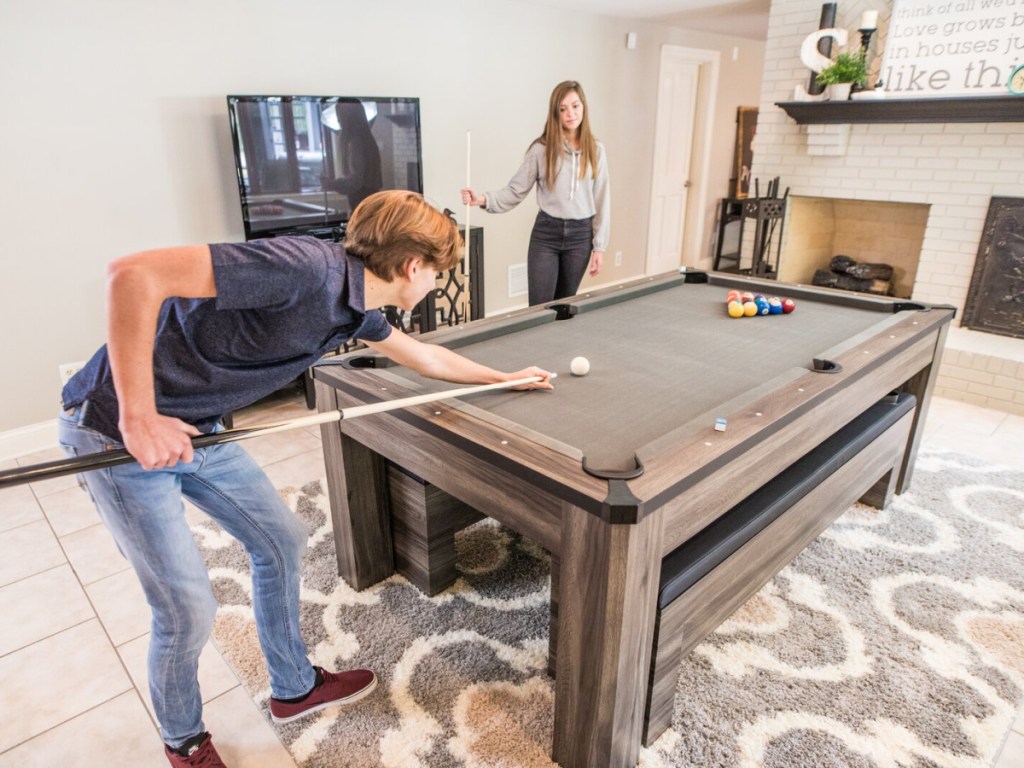 man and woman plying pool on an american legend game table